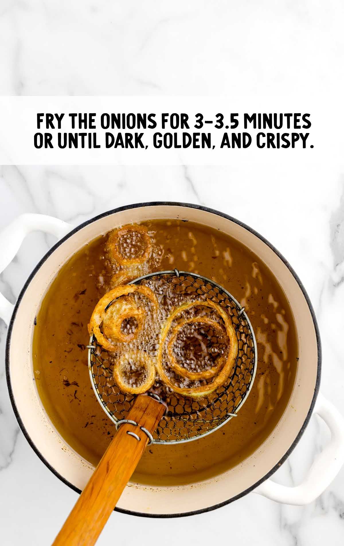 onion fried in a pot of hot oil