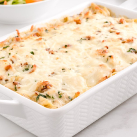 A rectangular baking dish of chicken pasta.