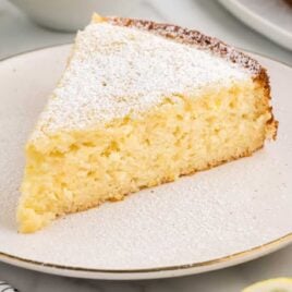 close up shot of a slice of Lemon Ricotta Cake on a plate
