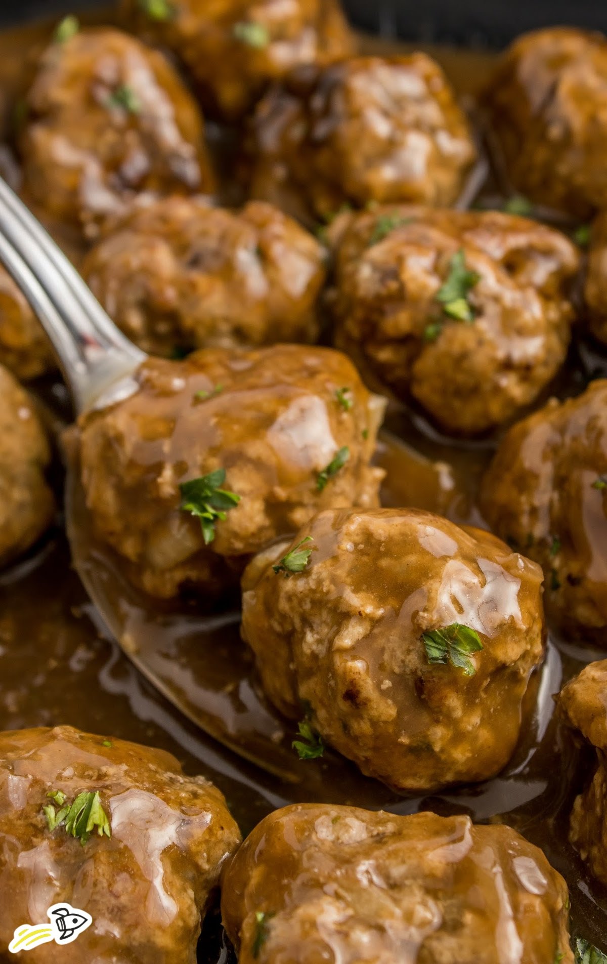 a close up of meatballs on a serving spoon