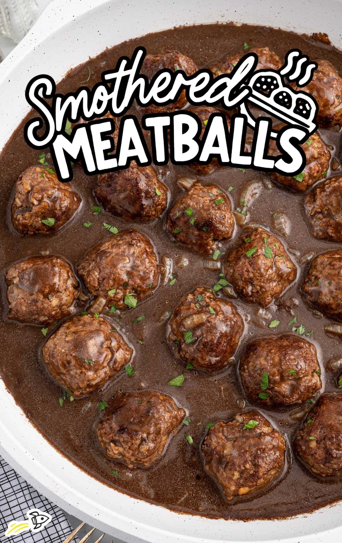 a pot of meatballs garnished with parsley