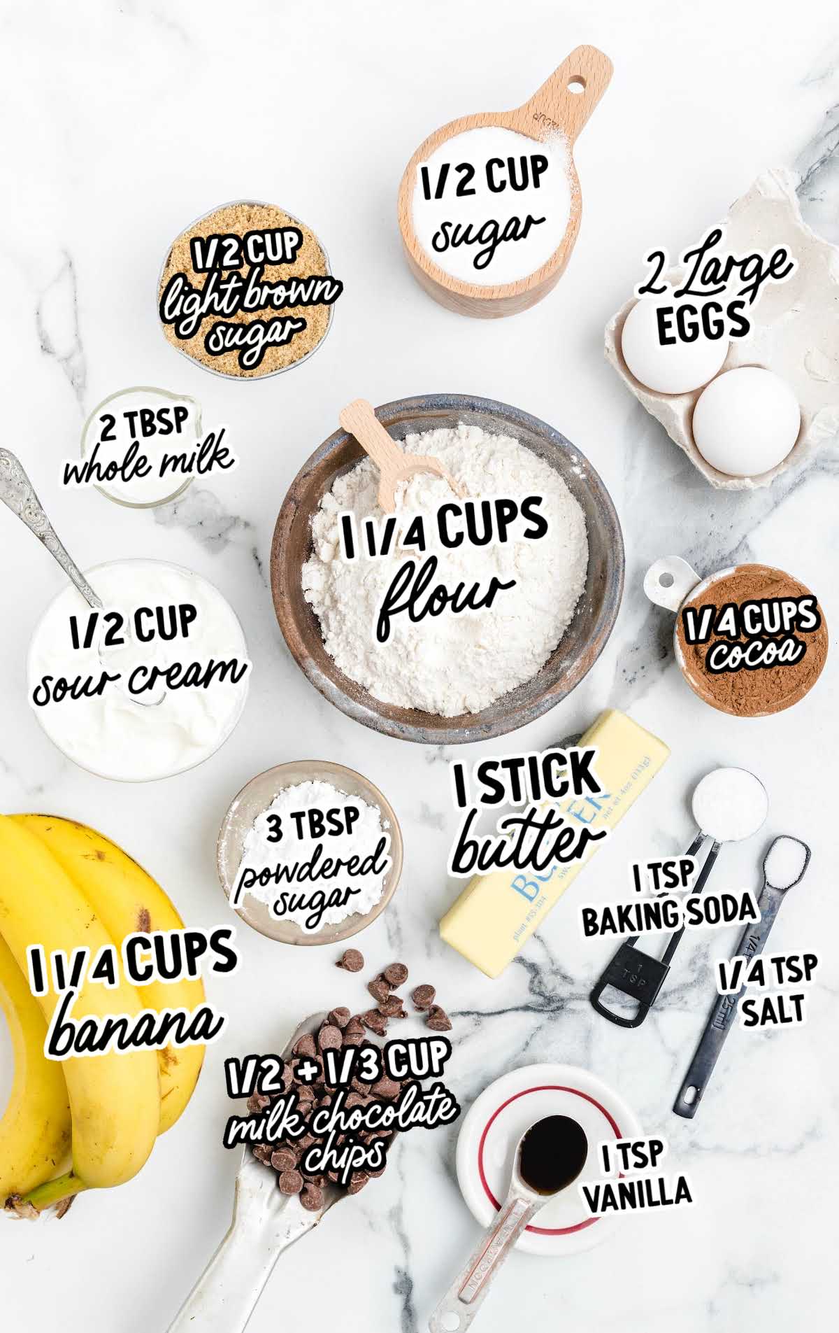Labeled baking ingredients for chocolate banana bread including bananas, flour, sugars, cocoa, and chocolate chips.