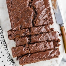 Overhead view of thick, sliced chocolate banana bread loaf with glossy glaze.