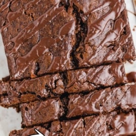 Overhead of stacked chocolate banana bread slices with chocolate chips and glaze, text reads “The Very Best Chocolate Banana Bread.”