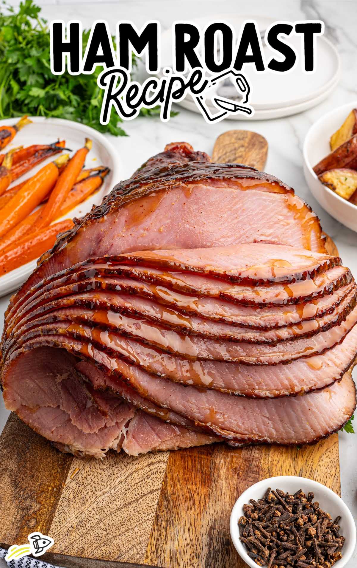 Close-up of juicy spiral cut ham with a shiny honey glaze on a wooden cutting board.