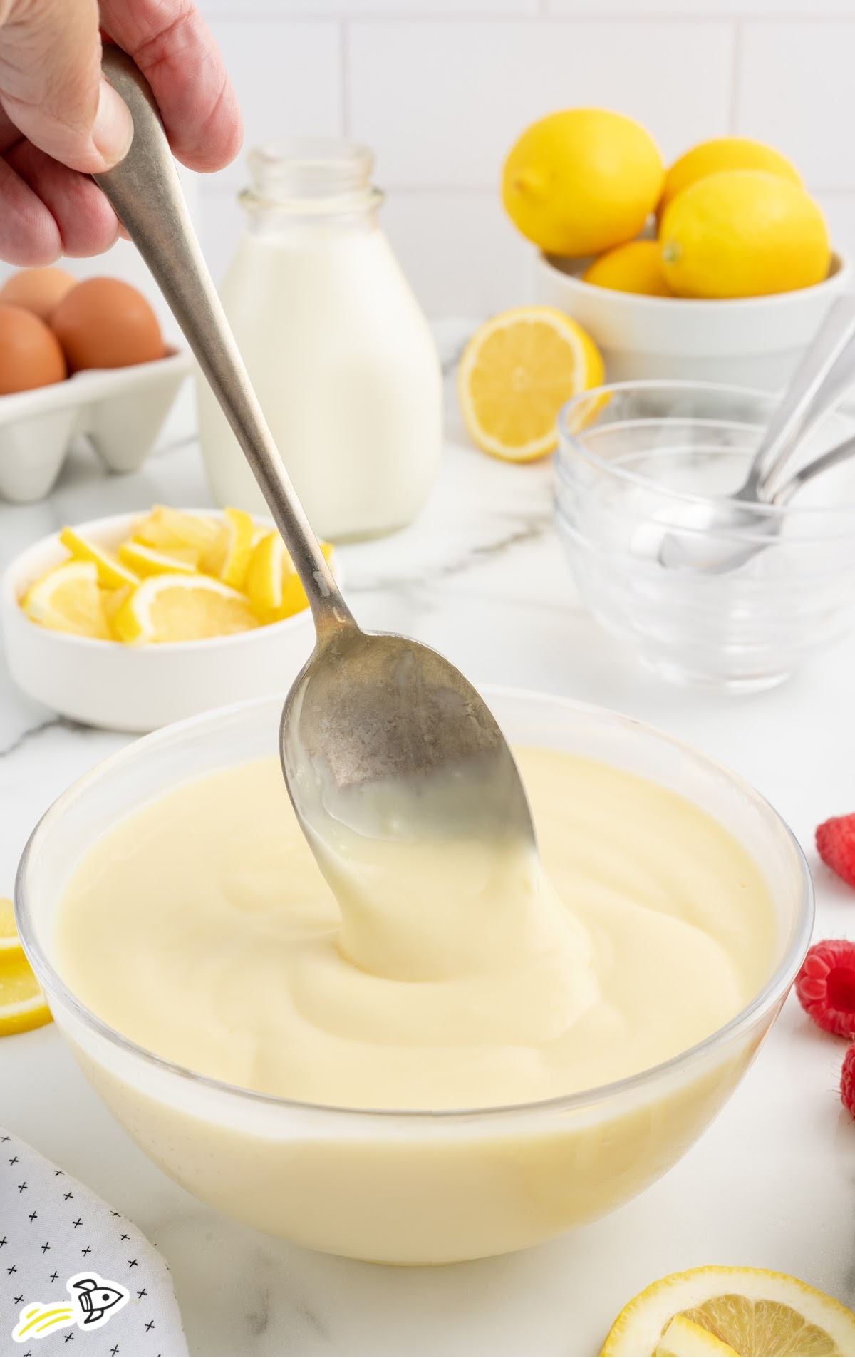 lemon custard in a small bowl with a spoon
