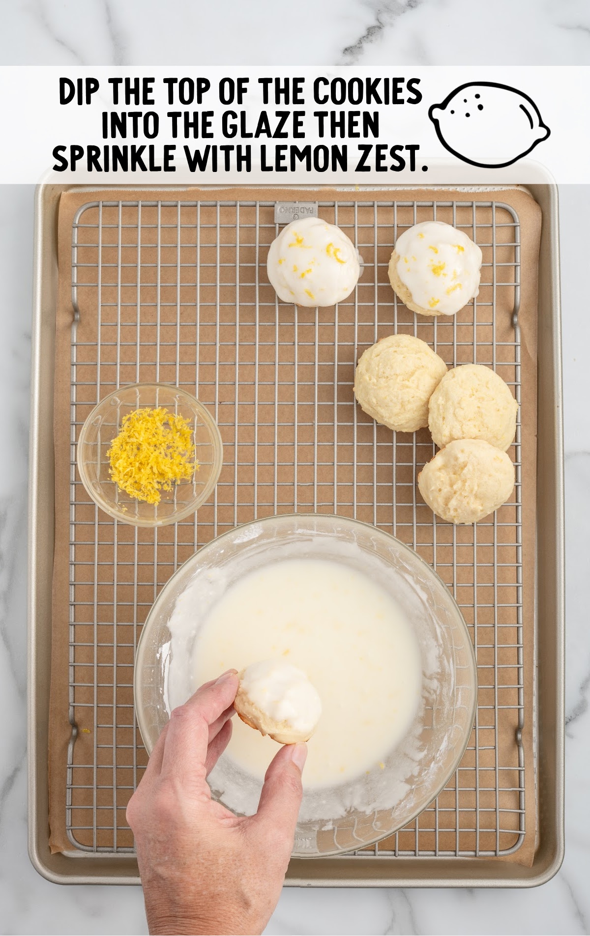 dipping baked ricotta cookies into homemade lemon icing