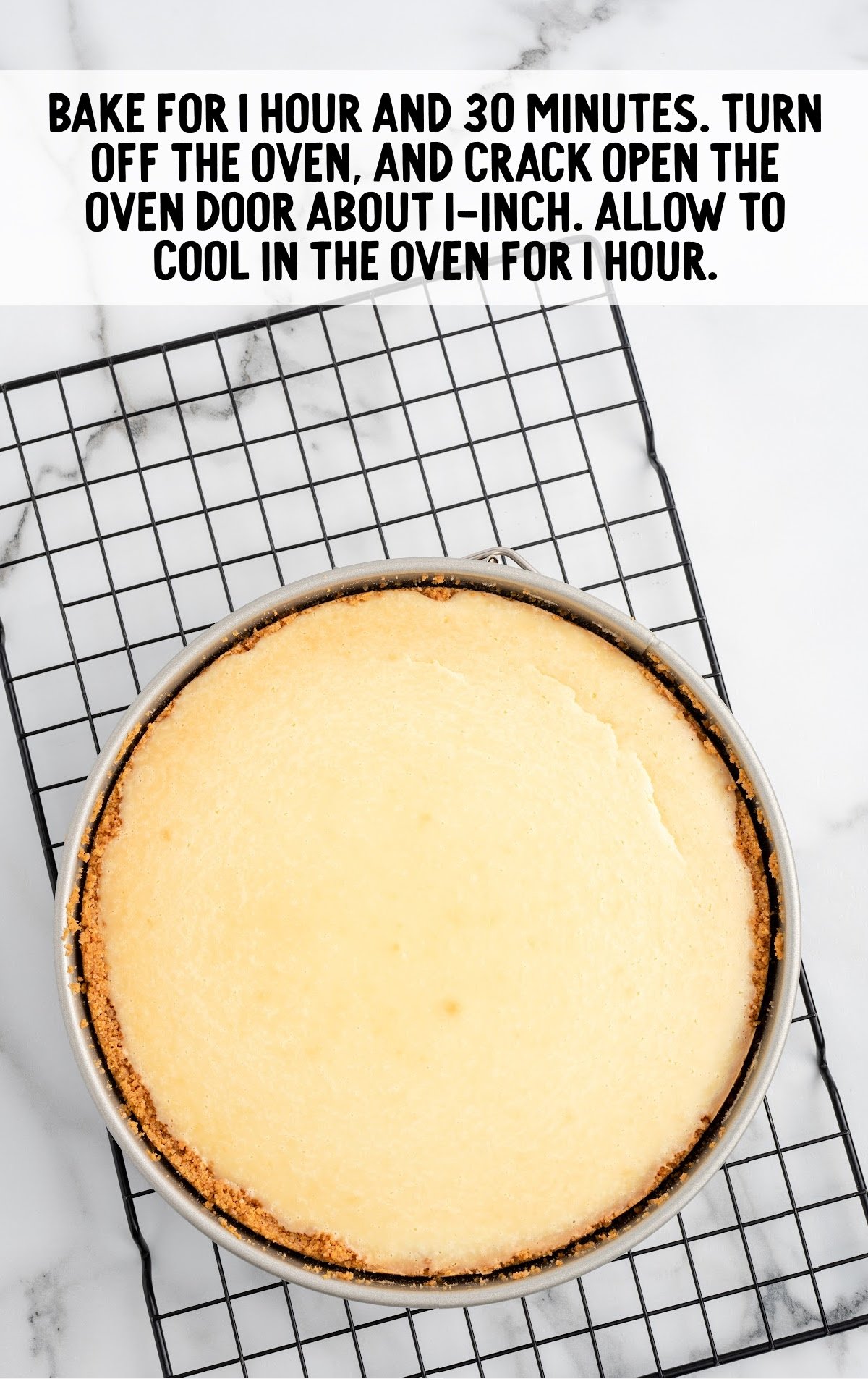 baked cheesecake on a cooling rack still sitting in pan