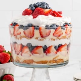 a jar of 4th of July Trifle topped with diced strawberries and blueberries