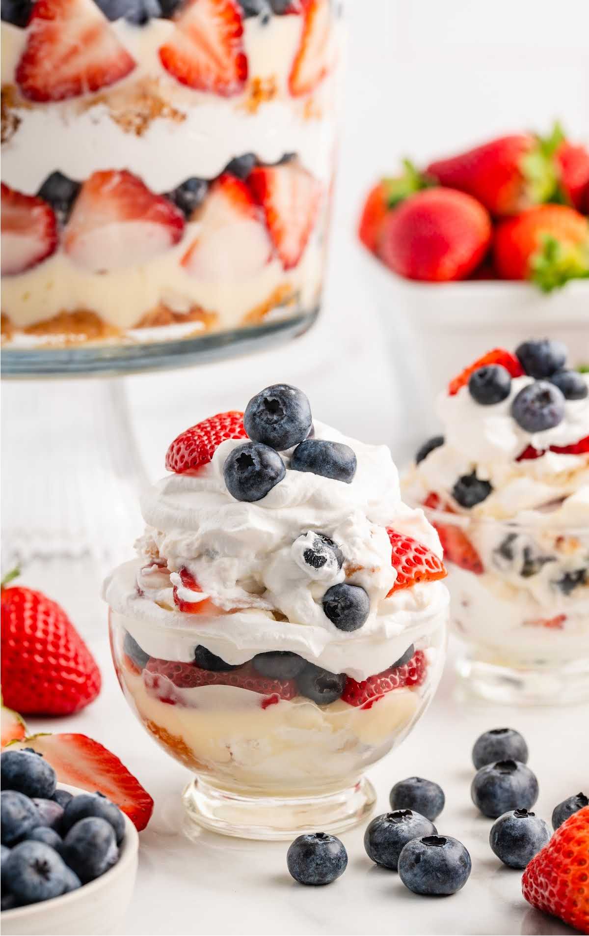 a cup of 4th of July Trifle topped with diced strawberries and blueberries