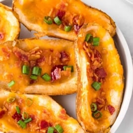 a plate of Baked Potato Skins garnished with green onions