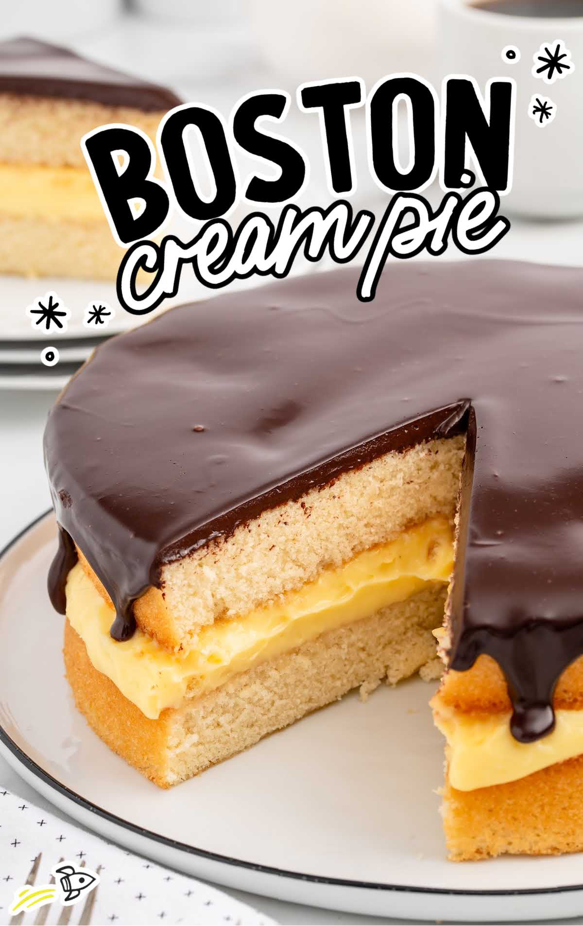 Boston Cream Pie with a slice missing on a plate