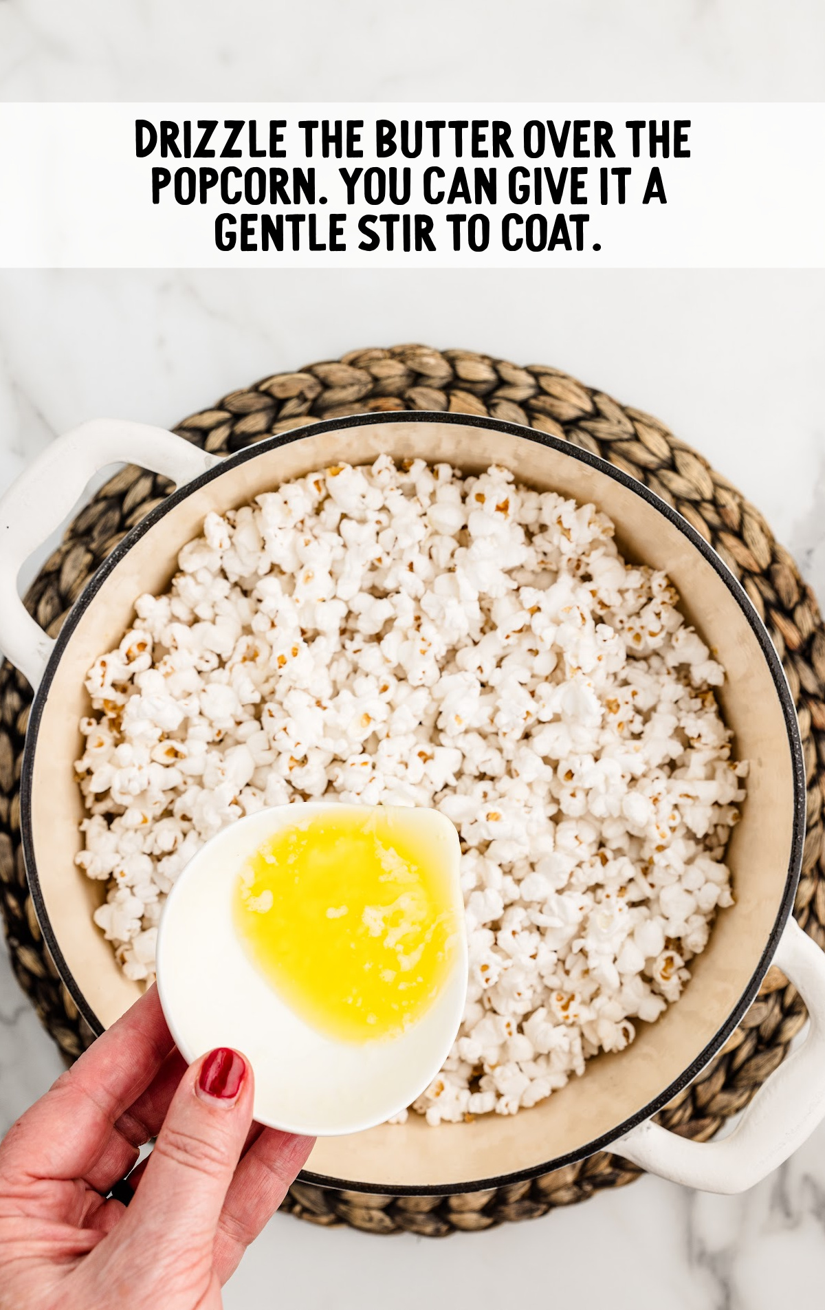 Butter is drizzled over the popped popcorn. 