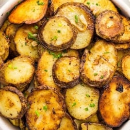 a bowl of fried potatoes topped with chives