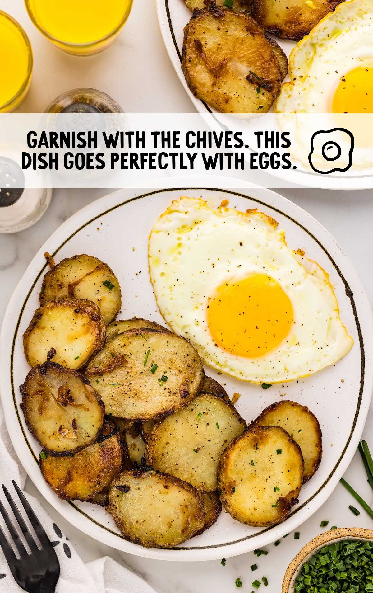 fried potatoes garnished with chives and served with eggs on a plate