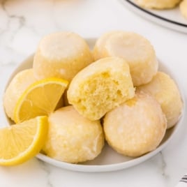 a plate of Lemon Drop Cakes with slices of lemons
