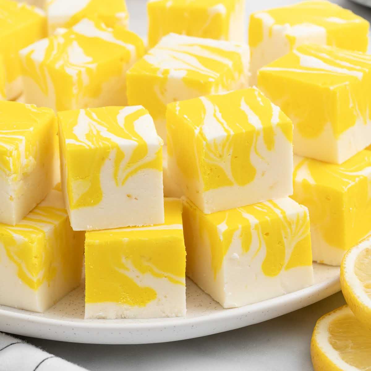 a bunch of Lemon Fudge bars on a plate