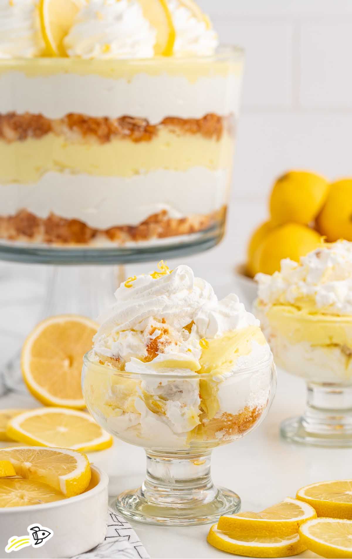 a jar of Lemon Trifle topped with whipped topping and slices of lemon
