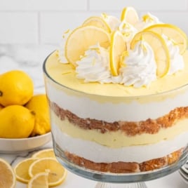 a jar of Lemon Trifle topped with whipped topping and slices of lemon