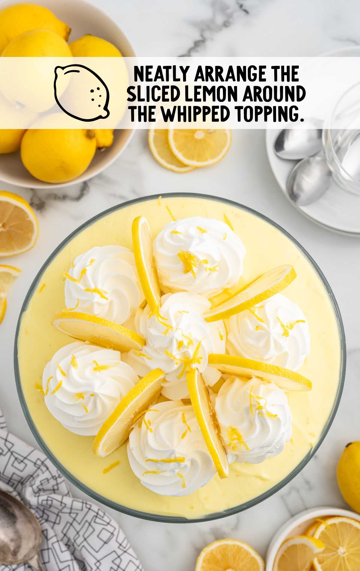 Lemon Trifle topped with lemon slices around the whipped cream swirls 