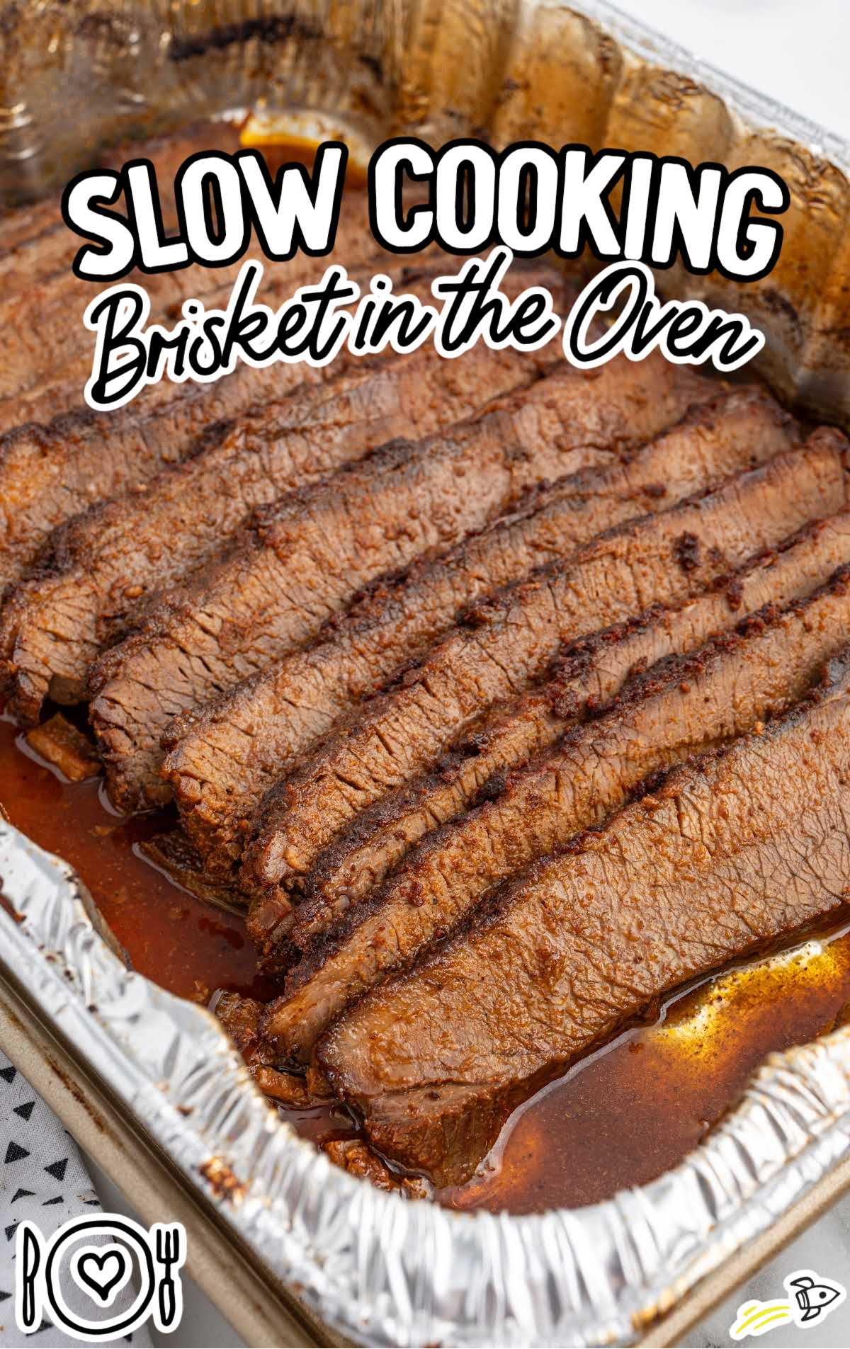 a cooked brisket in a aluminum foil pan