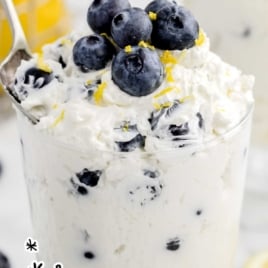 a cup of Blueberry Cheesecake Salad topped with blueberries and lemon zest