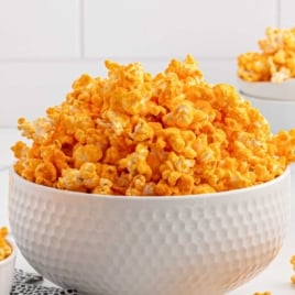 A bright and engaging image featuring a full bowl of cheese popcorn with an easy-to-read recipe card overlay listing ingredients and steps.