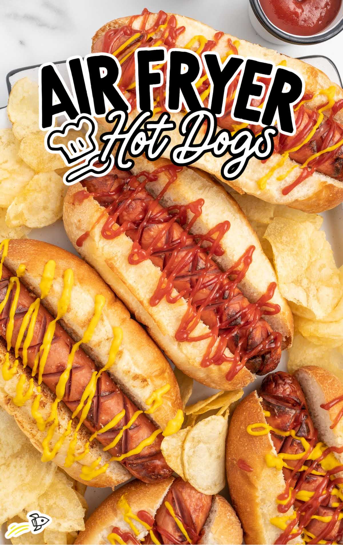 Hot Dogs topped with ketchup and mustard served with chips