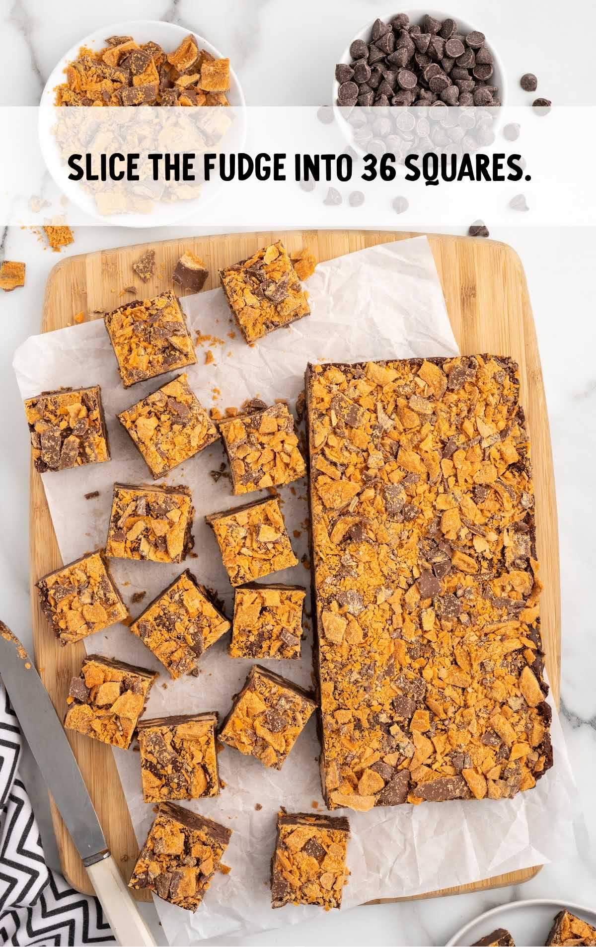 Butterfinger Fudge sliced into squares on a wooden board
