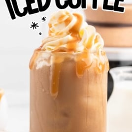 a glass of Caramel Iced Coffee topped with whipped topping and drizzled with caramel sauce