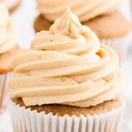 A close up shot of a cupcake topped with caramel icing