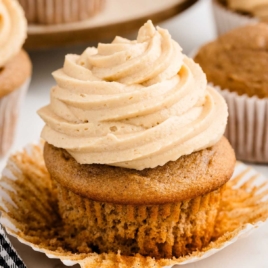 A close up shot of a cupcake topped with caramel icing