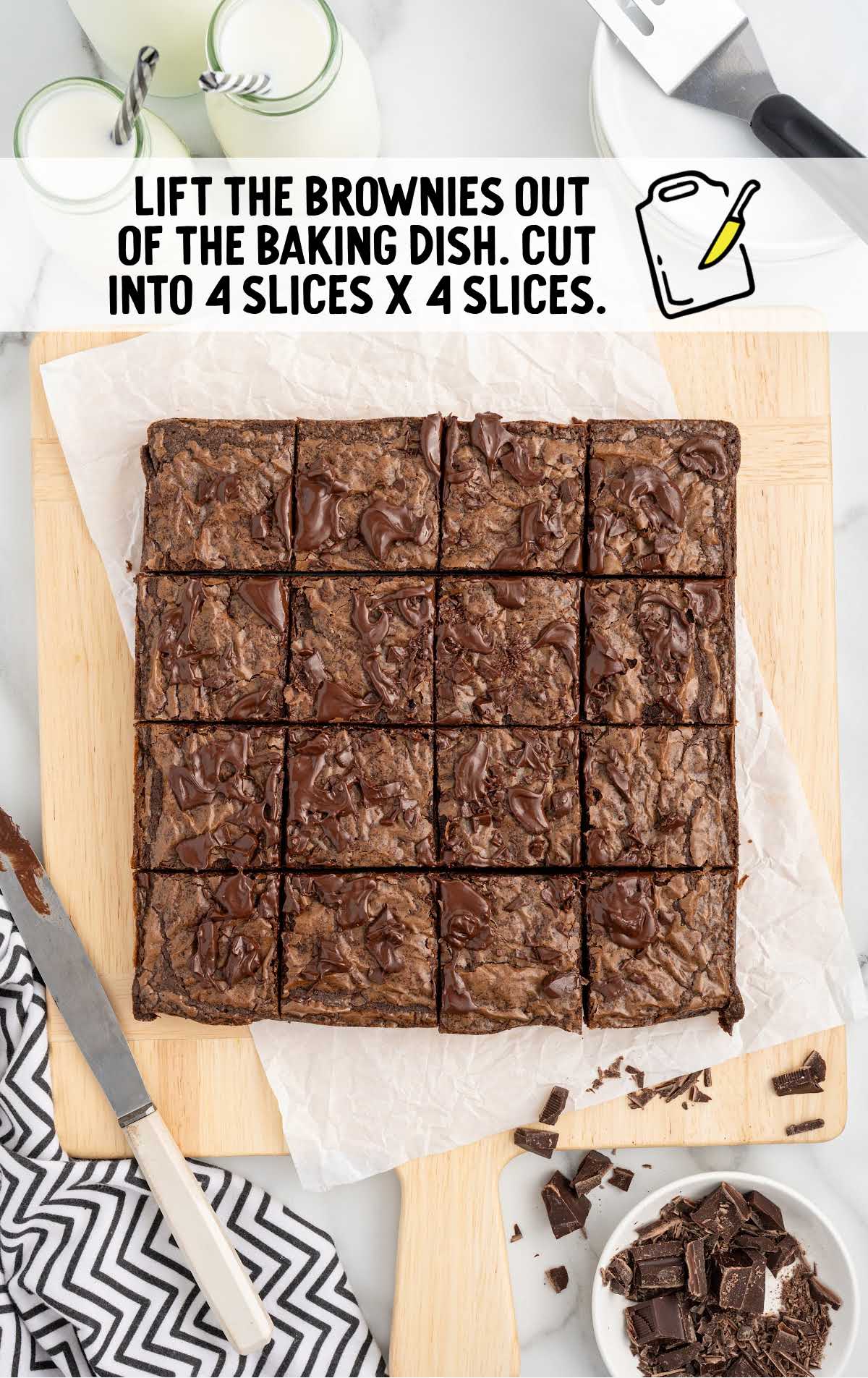 brownies sliced with a knife on a wooden cutting board