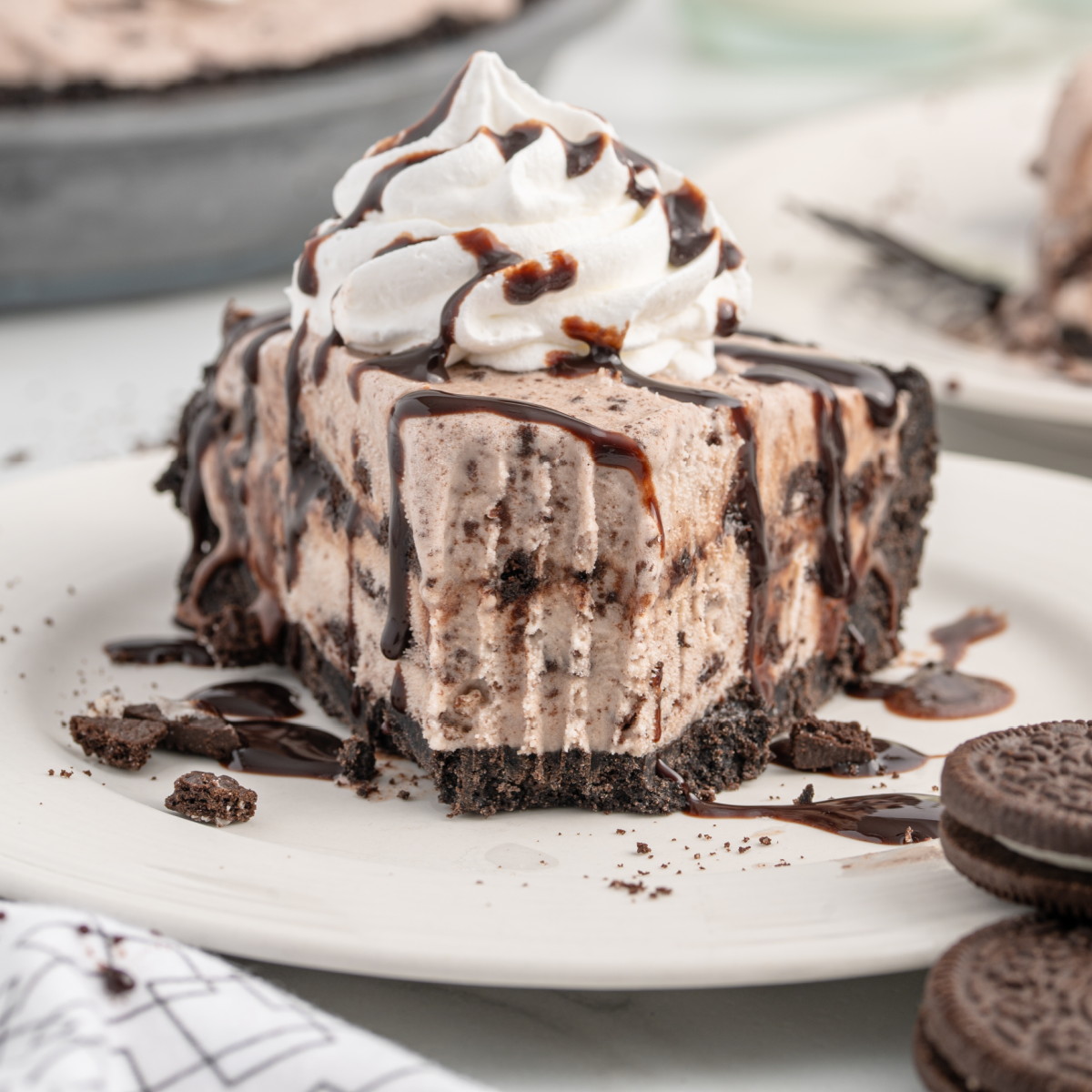 A piece of chocolate cake on a plate, with Cream