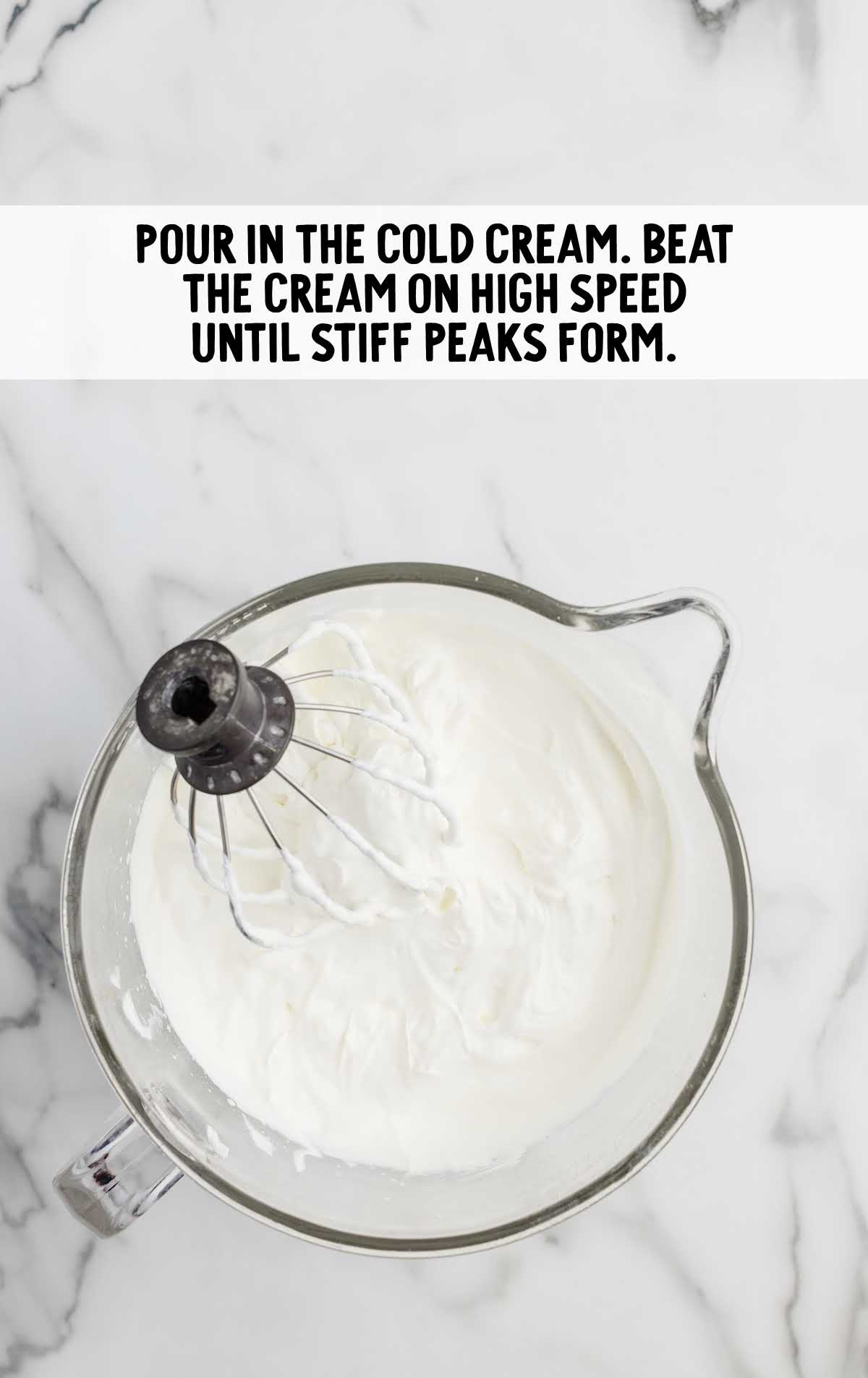 cold heavy cream whisked in a measuring cup