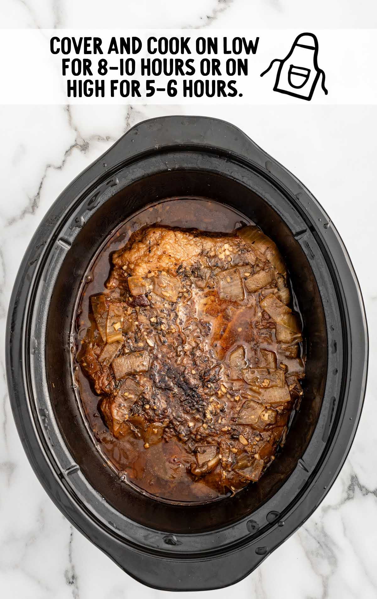brisket covered and cooked in a slow cooker