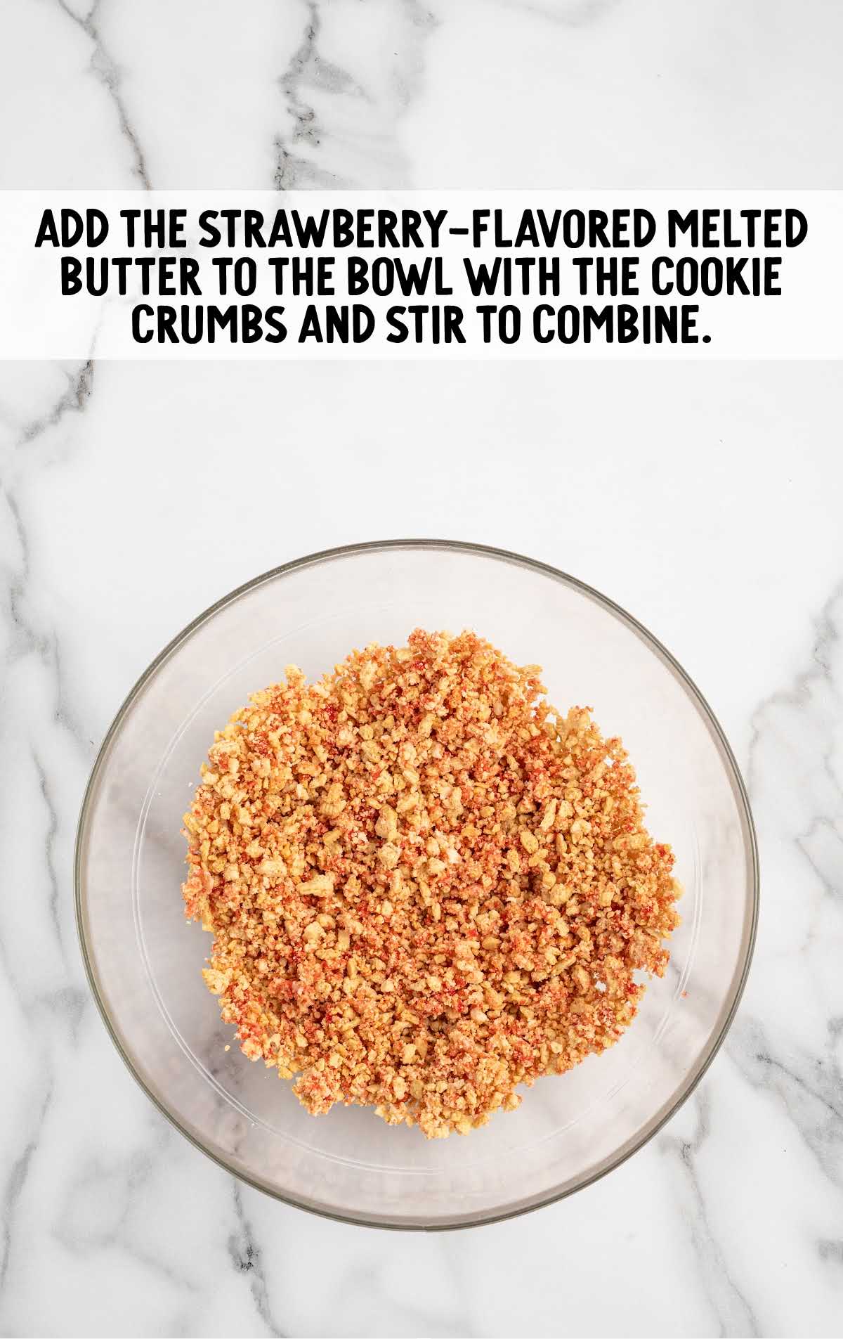 strawberry flavored melted butter added to the bowl with the cookie crumbs