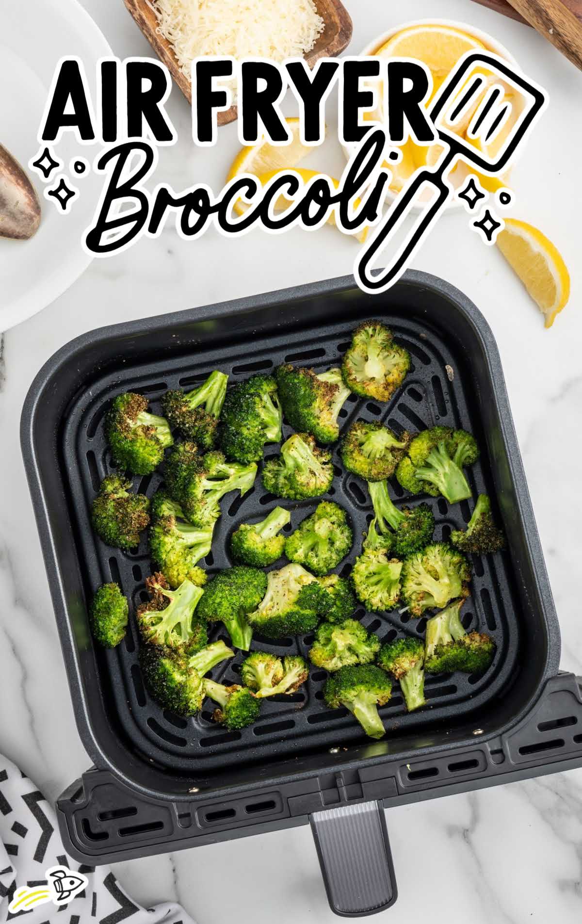 Overhead shot of pieces of broccolis in a air fryer
