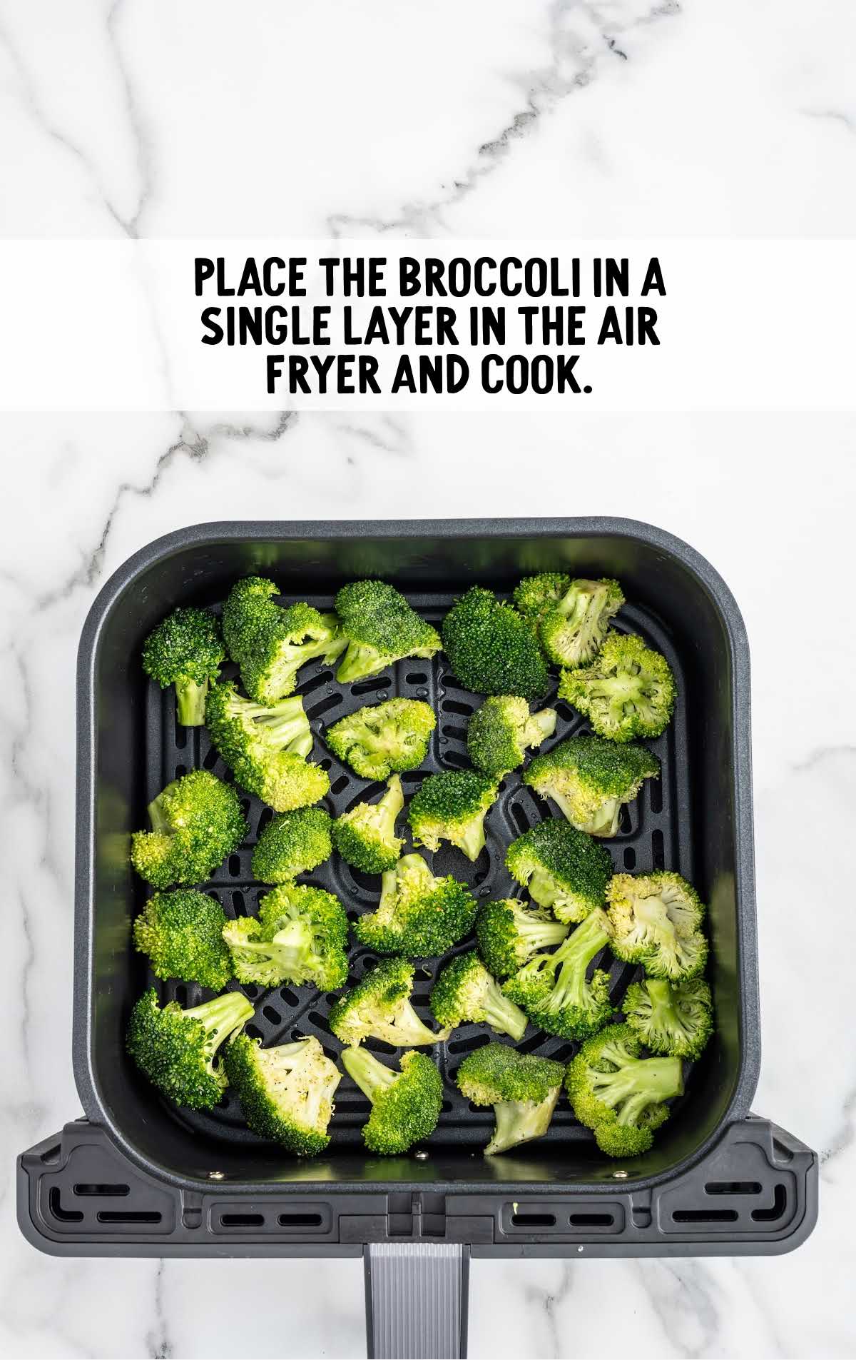 Broccoli pieces placed in a air fryer and cooked