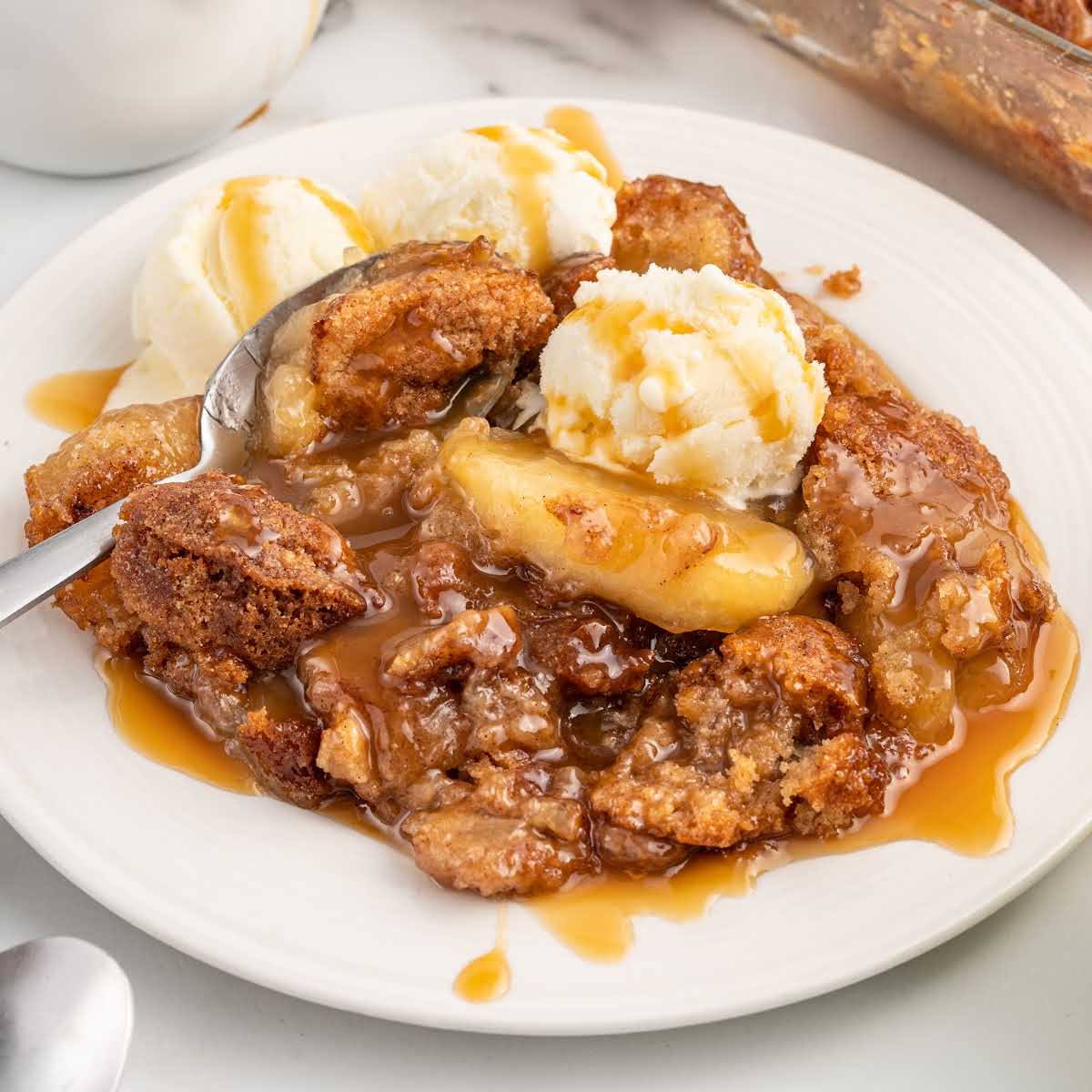 a close up shot of a piece of Snickerdoodle Cobbler on a plate