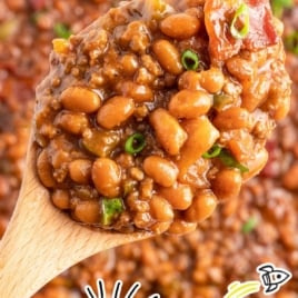 a skillet of Baked Beans with Ground Beef garnished with green onions