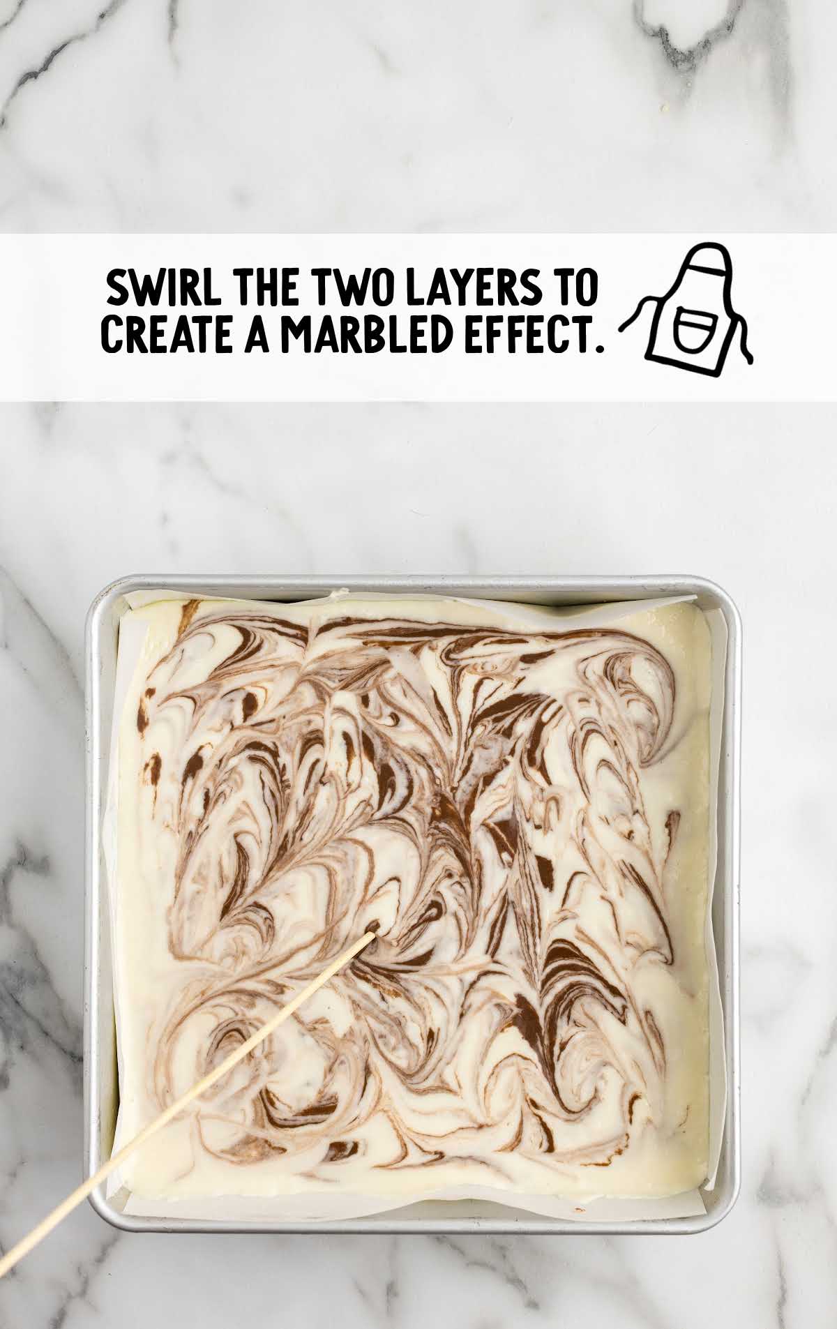 cocoa-flavored fudge mixture on top of the white fudge layer swirled in a pan