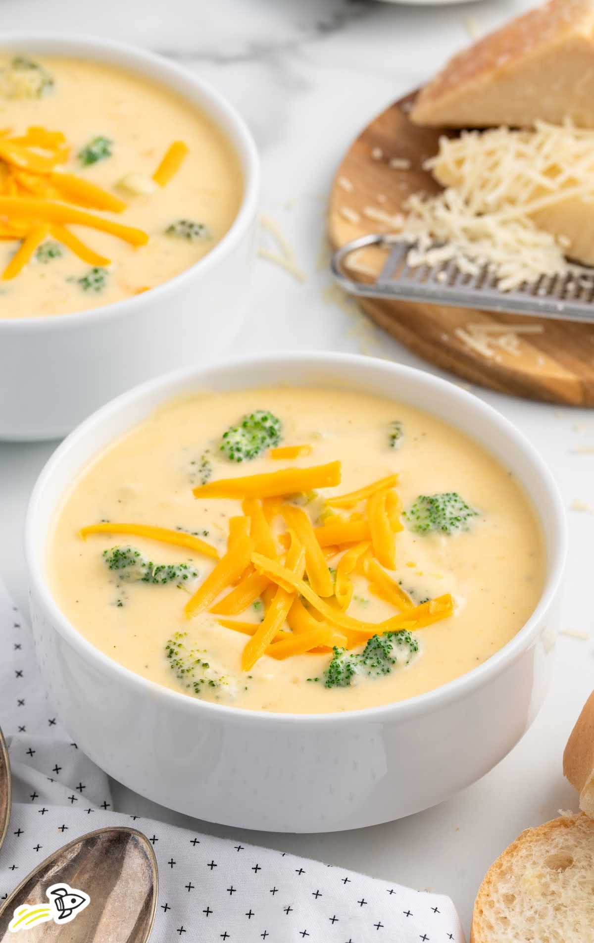 a bowl of Broccoli Cheese Soup topped with cheese