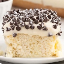 a slice of Cannoli Poke Cake on a plate