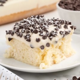 a slice of Cannoli Poke Cake on a plate