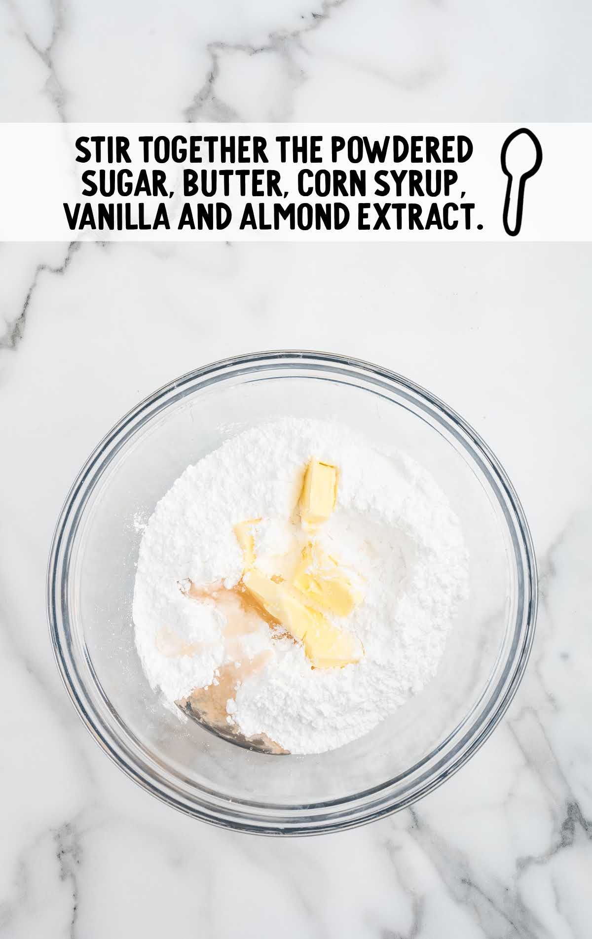 sifted powdered sugar, softened butter, light corn syrup, vanilla extract, and almond extract added to a bowl