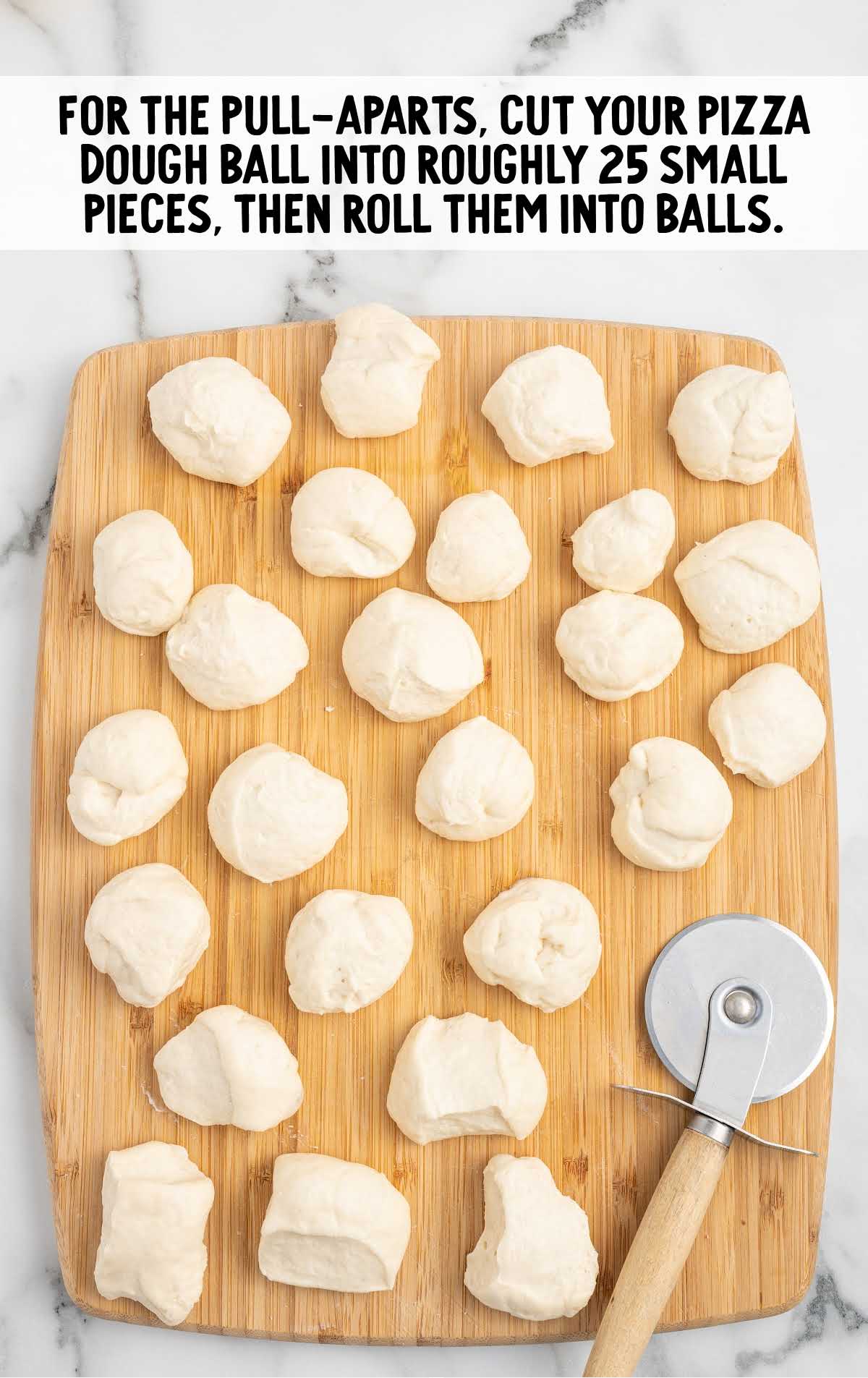 dough rolled into balls on a wooden board