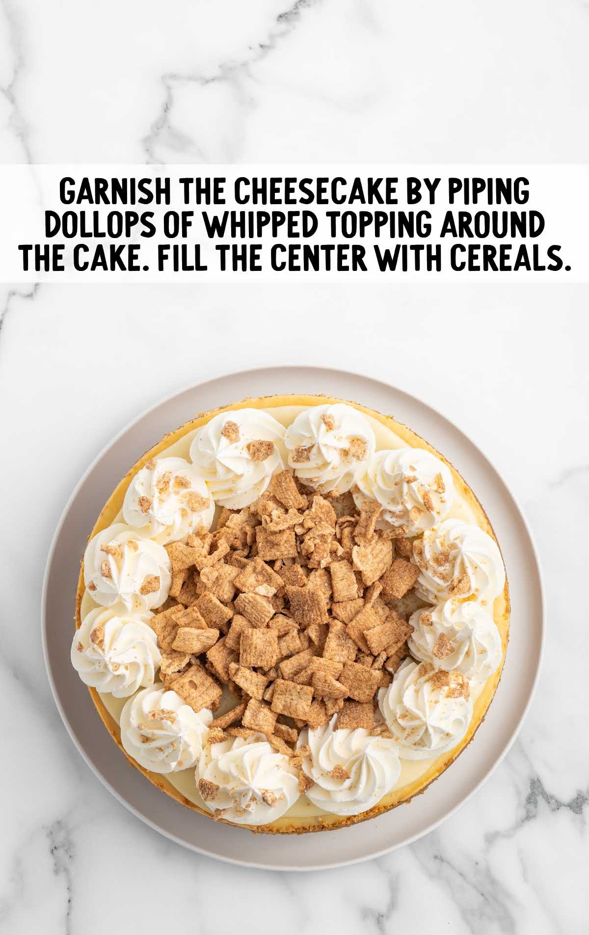 Cinnamon Toast Crunch Cheesecake topped with whipped topping and crushed cereal