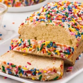 a loaf of Ice Cream Bread with some slices on a plate on a plate