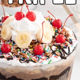 a jar of Ice Cream Trifle topped with sprinkles, banana slices, cherries, and whipped topping